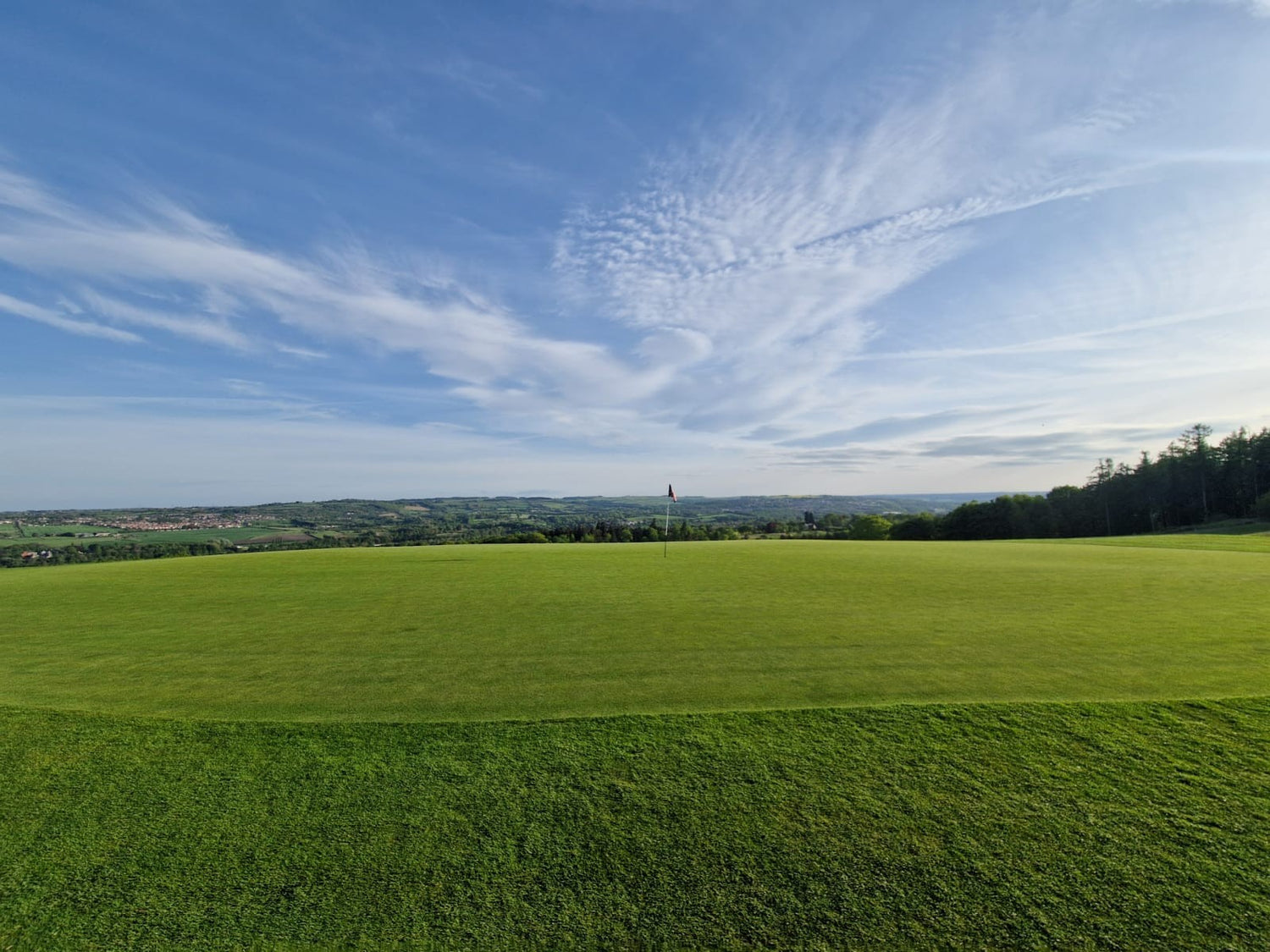 Close house golf course on a sunny day on a green with flag 